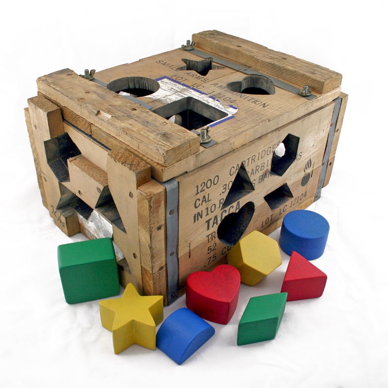 Product Description: Matching Holes</br></br>AAron Earley</br></br>9x18x14</br></br>2022</br></br>Wooden ammo crate, graphite, sapele, epoxy paints</br></br>$4,600</br> Matching Holes by Aaron Earley