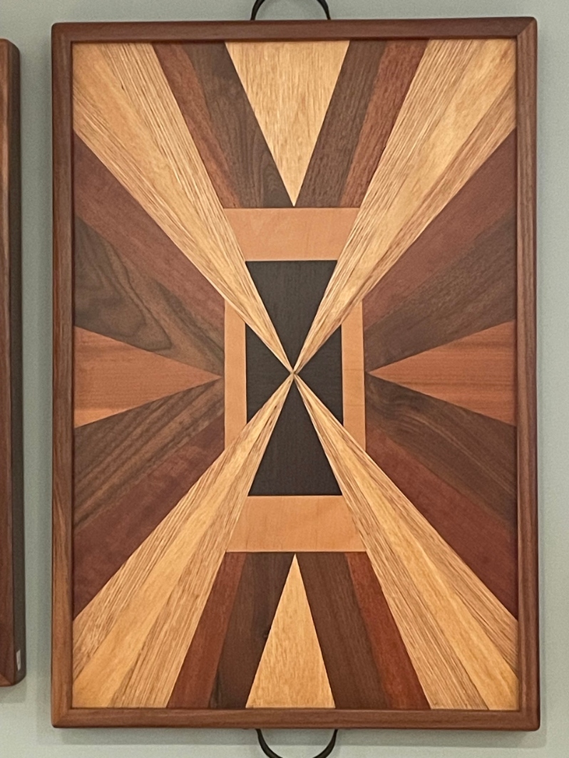 Product Description: Serving Tray #17 by CrisEklund</br></br>25x17x2</br></br>2023</br></br>Exotic wood veneers with sold banding</br></br>$225</br> Serving Tray #17 by Cris Eklund